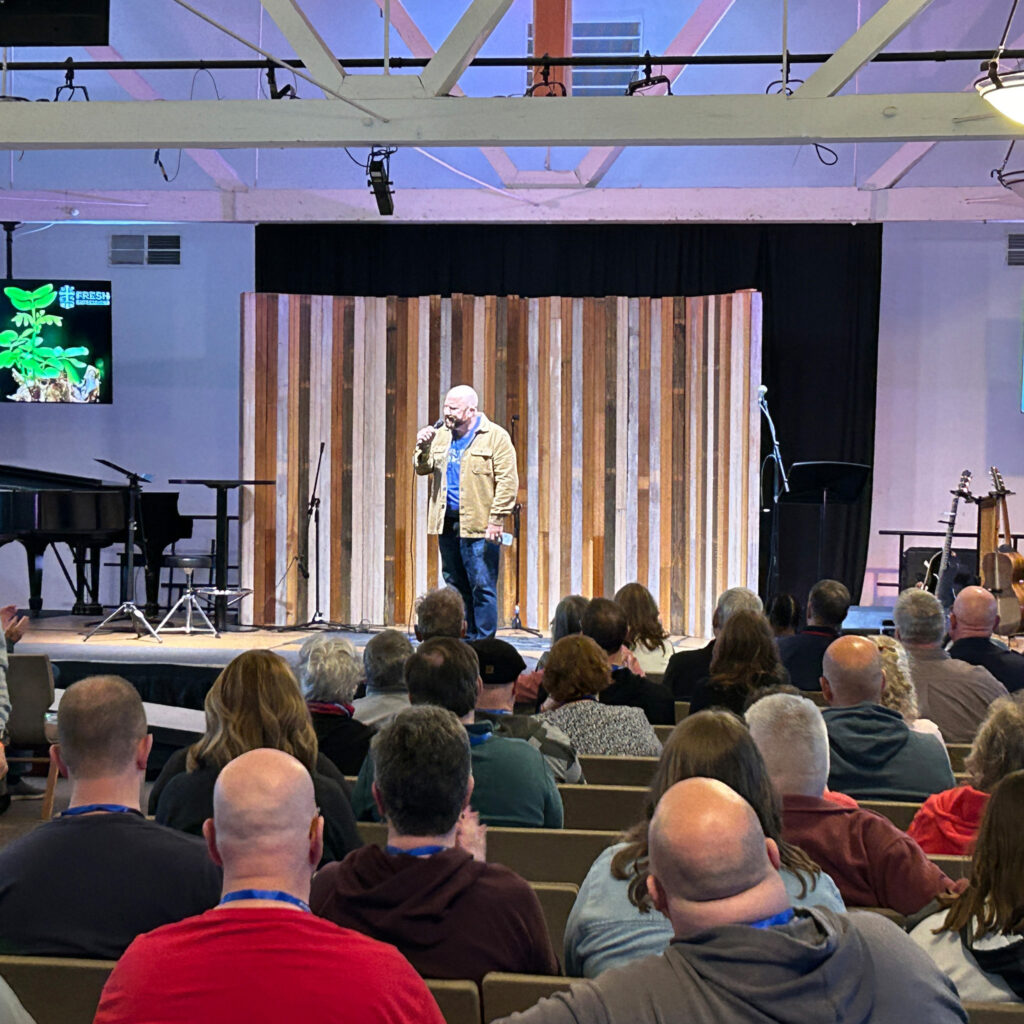 Tim Palmer giving a comedy keynote at a retreat